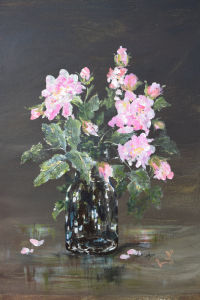 Pink roses in a glass bottle