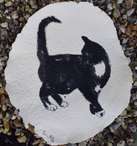 Black cat on hand made paper